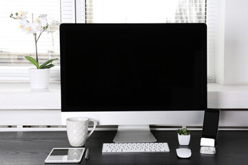 Canvas Print - Modern comfortable workplace with computer and window blinds