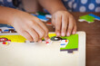 © pingpao - Child little girl hand trying to connect jigsaw puzzle piece to learn to find solution