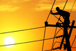 Shadow electricians repairing wire on electric power pole at the sunset blur