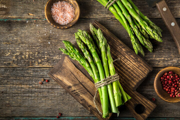 banches of fresh green asparagus on wooden background