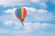 Hot air baloon with clouds blue sky background
