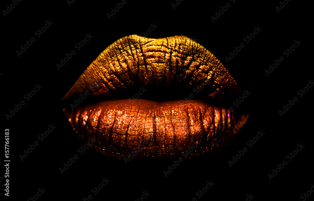 Golden brown lipstick on lips isolated on black background. Sexy lips, female mouth. Imprint lips. Luxury cosmetics for girls and women. Beautiful female lips. Female beauty concept girl - obrazy, fototapety, plakaty 