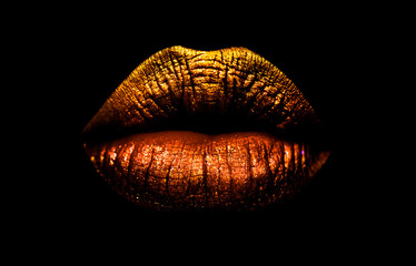 golden brown lipstick on lips isolated on black background. sexy lips, female mouth. imprint lips. l