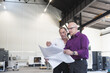 © Westend61 - Two businessmen looking at plan in factory shop floor