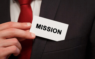 Poster - Businessman putting a card with text Mission in the pocket