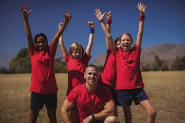 Wall Mural - trainer and kids relaxing in the boot camp
