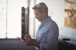 © WavebreakMediaMicro - Mature businessman using digital tablet at office