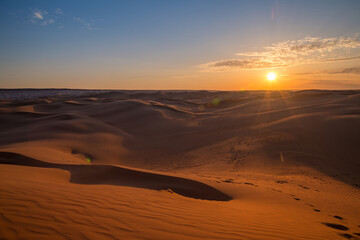 Beautiful sunset in sand dunes over barkhan desert in Kazakhstan