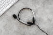 © 9dreamstudio - call center manager work with headset on stone desk background top view