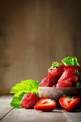 Ripe juicy strawberries on a wooden table.