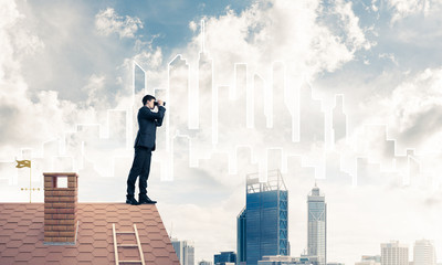 Businessman standing on roof and looking in binoculars. Mixed me