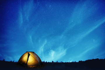 illuminated camping tent at night