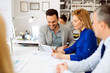 © NDABCREATIVITY - Businesspeople collaborating in office