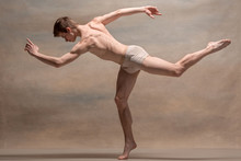 The Male Ballet Dancer Posing Over Gray Background