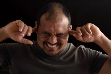 Wall Mural - Portrait of a latin man with noise on black background