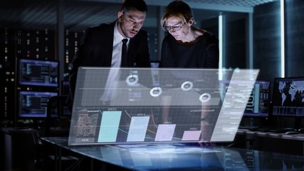 Aufkleber - Male and Female Business Managers Use Touchscreen Interactive 3D Panel in Big Monitoring Room Full of Computers with Animated Screens. Shot on RED EPIC-W 8K Helium Cinema Camera.