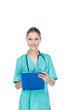 © LIGHTFIELD STUDIOS - young nurse writing at clipboard and looking at camera isolated on white