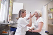 © Astrakan Images - Doctor examining senior woman's eyes