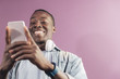 © santypan - Handsome african man using mobile.