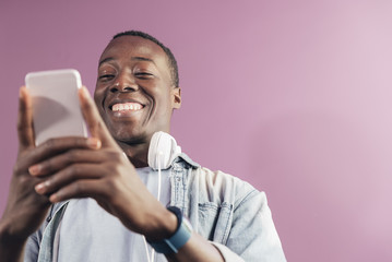 Handsome african man using mobile.