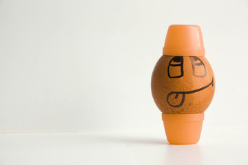 Egg with a cheerful painted face. Photo