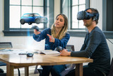Fototapeta Sypialnia - Business colleagues review automotive design concepts wearing a virtual reality headset.