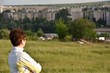 © st_fox - Woman looks from the hill to the city