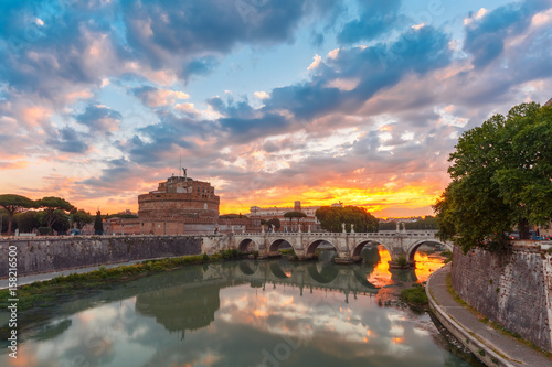 Fototapeta Saint Angel castle and bridge with mirror reflection in Tiber River during morning blue hour in Rome, Italy