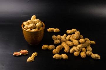 Peanuts in shell on dark background, close up