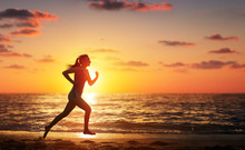 Runner Woman Running In The Beach At Sunset
