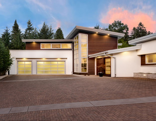 Beautiful and Large Luxury Home Exterior at Sunset with Colorful Sky