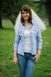 © AS Photo Family - Portrait of brunette girl on checkered shirt, jeans and veil at hen party.