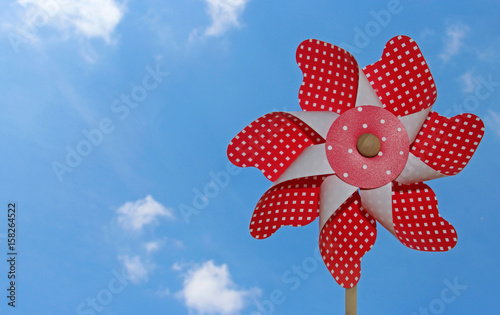 Red And White Pinwheel Against Blue Sky Buy This Stock Photo And