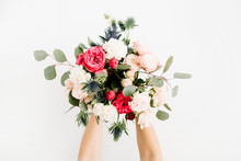 Girl's Hands Holding Beautiful Flowers Bouquet: Bombastic Roses, Blue Eringium, Eucalyptus, Isolated On White Background. Flat Lay, Top View. Floral Composition