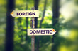 © pathdoc - Signpost with arrows pointing in opposite directions Foreign and Domestic