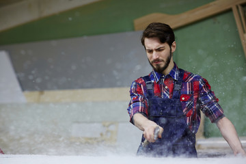 Wall Mural - Factory worker cooling rapid steel with special spray