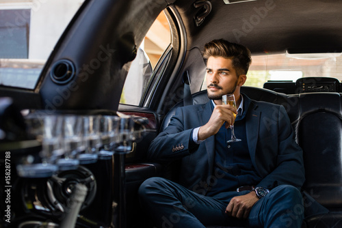 Business man and business woman in limousine Tableau sur Toile