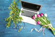 Beautiful flowers and laptop on florist's workplace