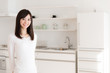 © taka - attractive asian woman relaxing in kitchen