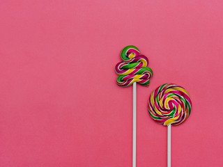 Lollipop Flat lay Minimal concept Two colorful lollipops on a pink background Round lollipop and a spiral lollipop