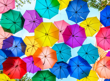 Multi-colored Umbrellas Background. Colorful Umbrellas Floating Above The Street. Street Decoration.