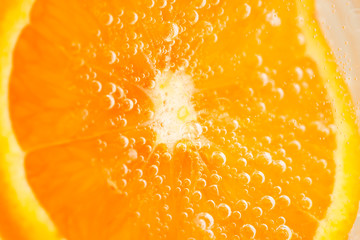 fresh orange with bubbles in the water