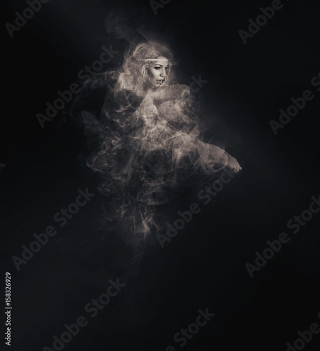 Fotografía Dancer from smoke on the dark background