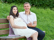 © soleg - happy couple in summer city park outdoor, pregnant woman, bright sunny day and green grass, beautiful people portrait