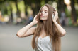 © lashkhidzetim - Pretty girl listening music with her headphones in the street