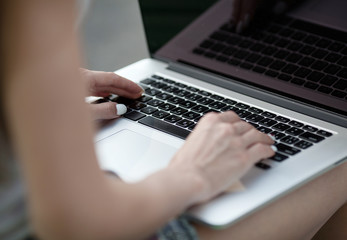 Poster - woman hands on a laptop. Selective focus.