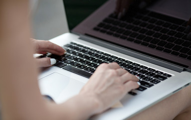 Poster - woman hands on a laptop. Selective focus.