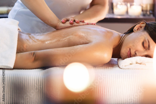 Fotografie, Obraz Body massage and spa treatment in modern salon with candles