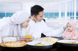 © Creativa Images - Young parents and girl having meal together