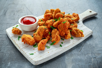 Wall Mural - fried crispy chicken nuggets with ketchup on white board